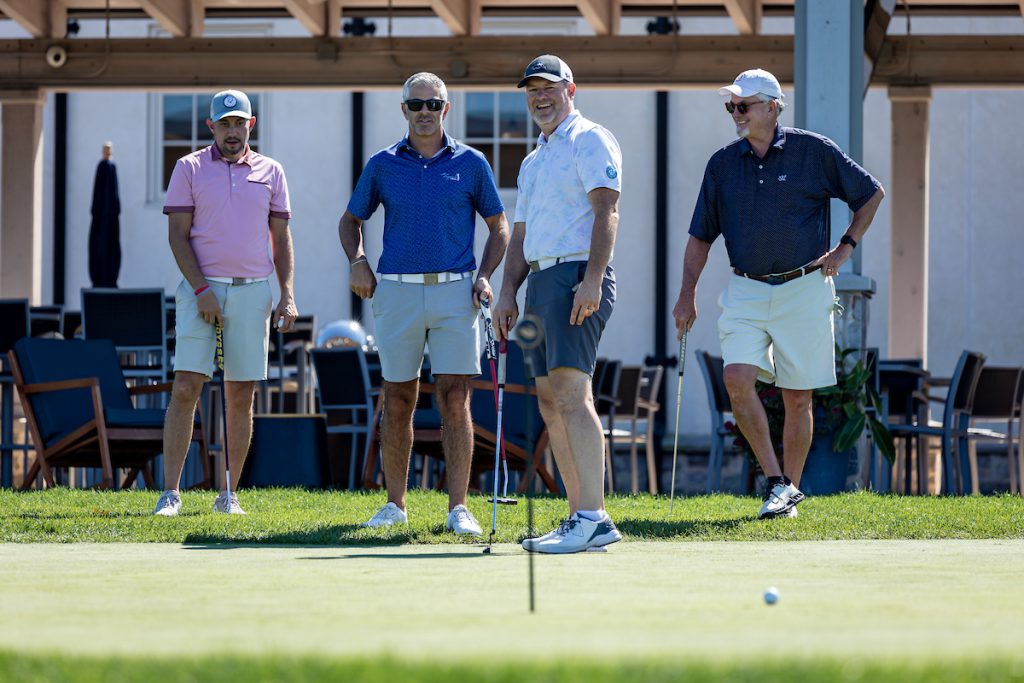 four men golfing