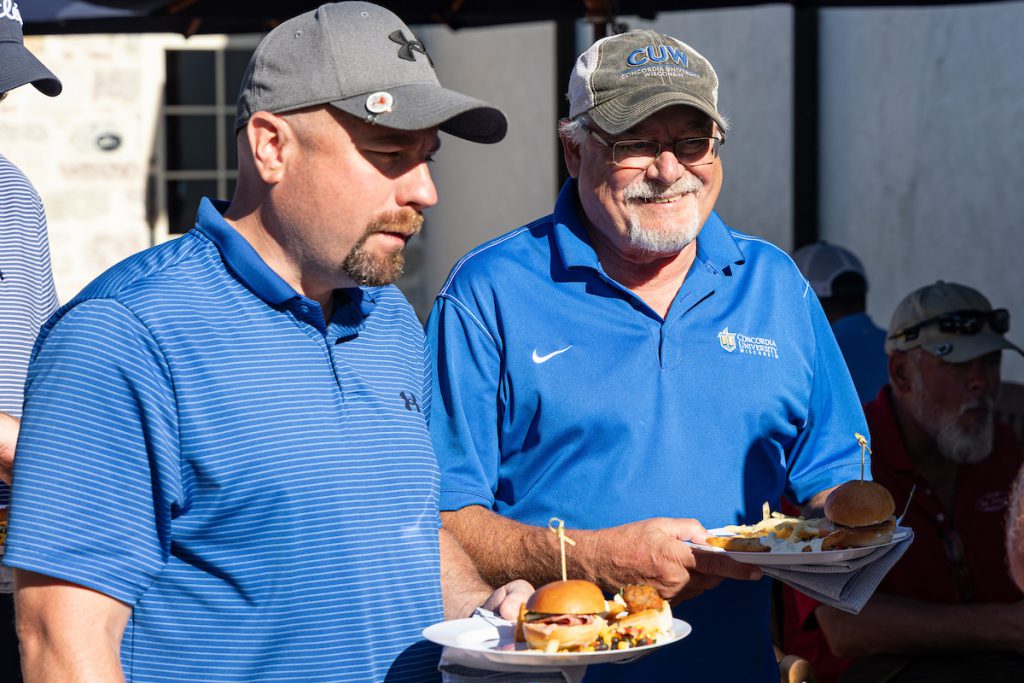 two guys eating and talking