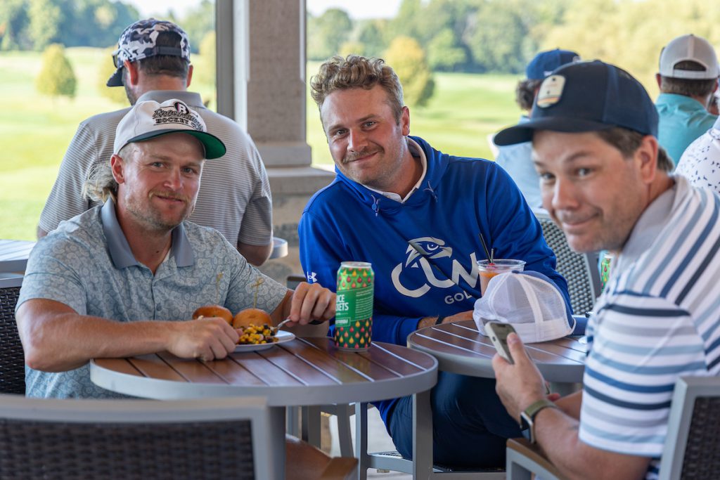 three guys eating at table