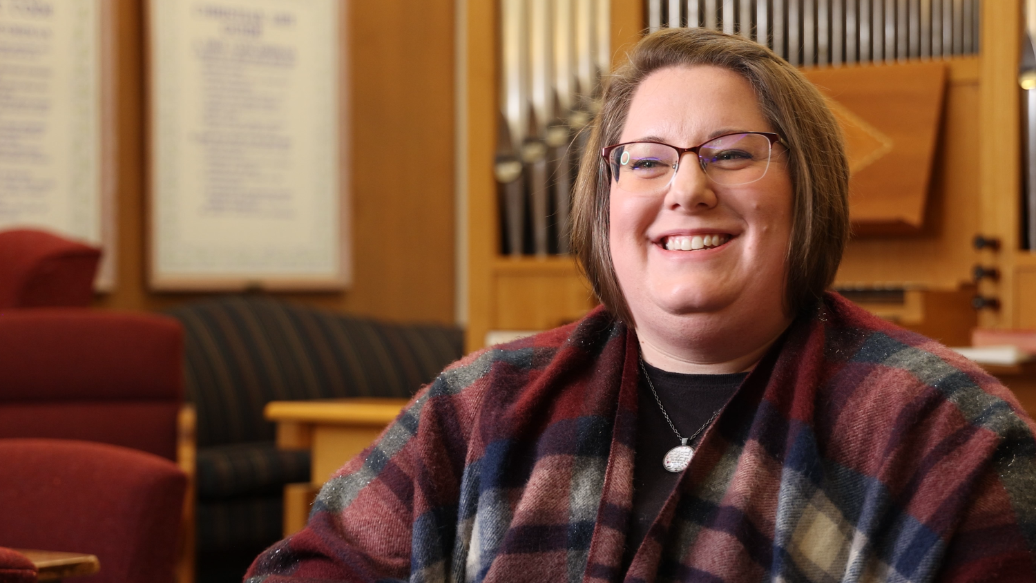 woman with glasses sitting