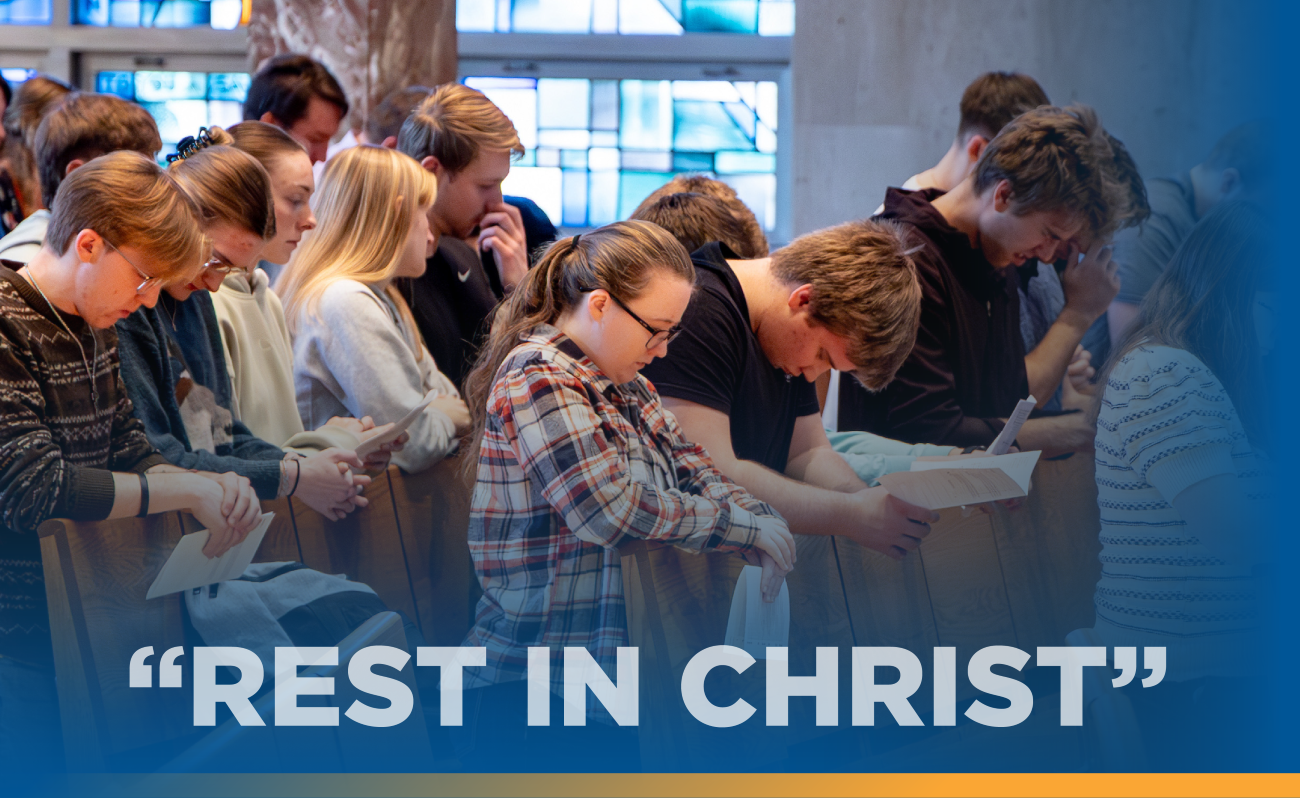student in chapel praying