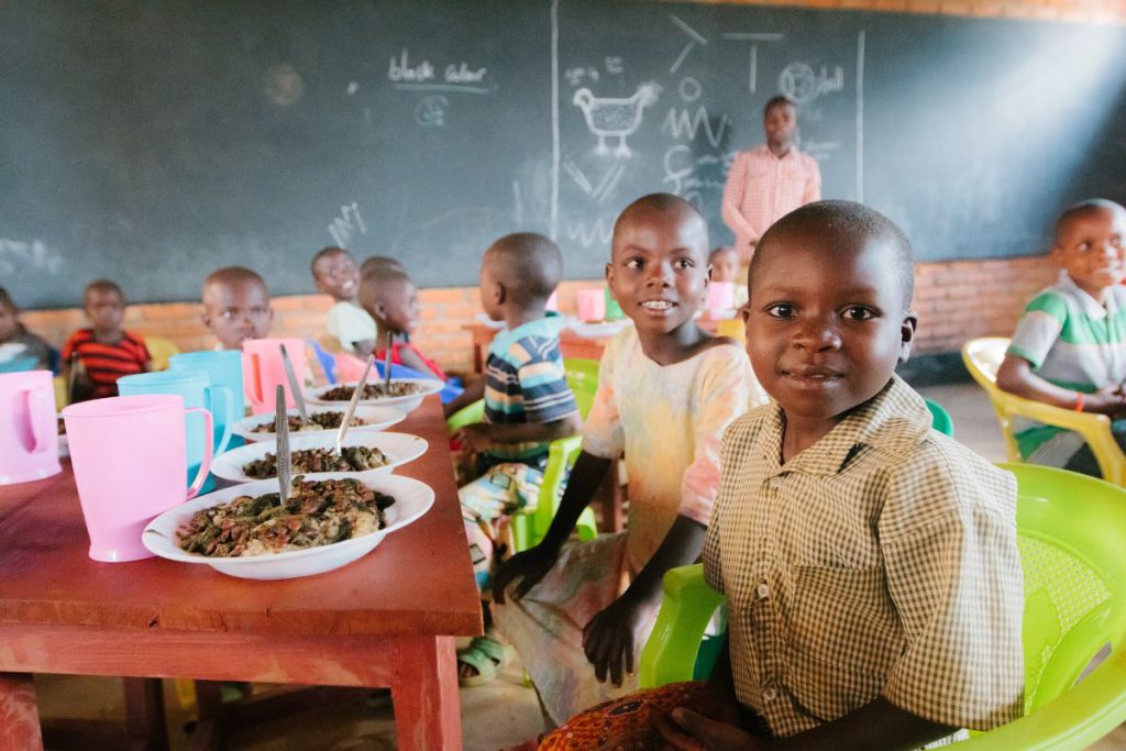 black boys smiling at a table