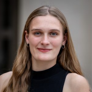 woman with light brown hair and black tank top