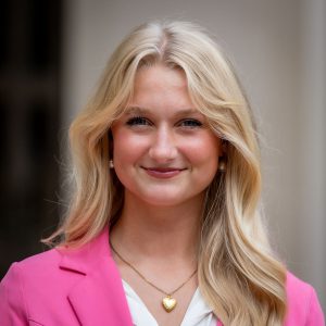 blonde with pink jacket