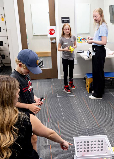 kids playing bean bag toss