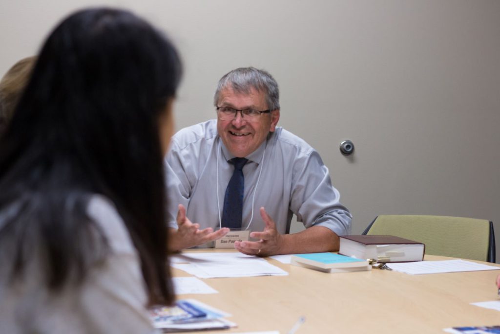 man with glasses sitting at table