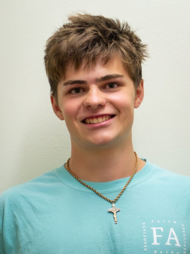 boy with brown hair and cross