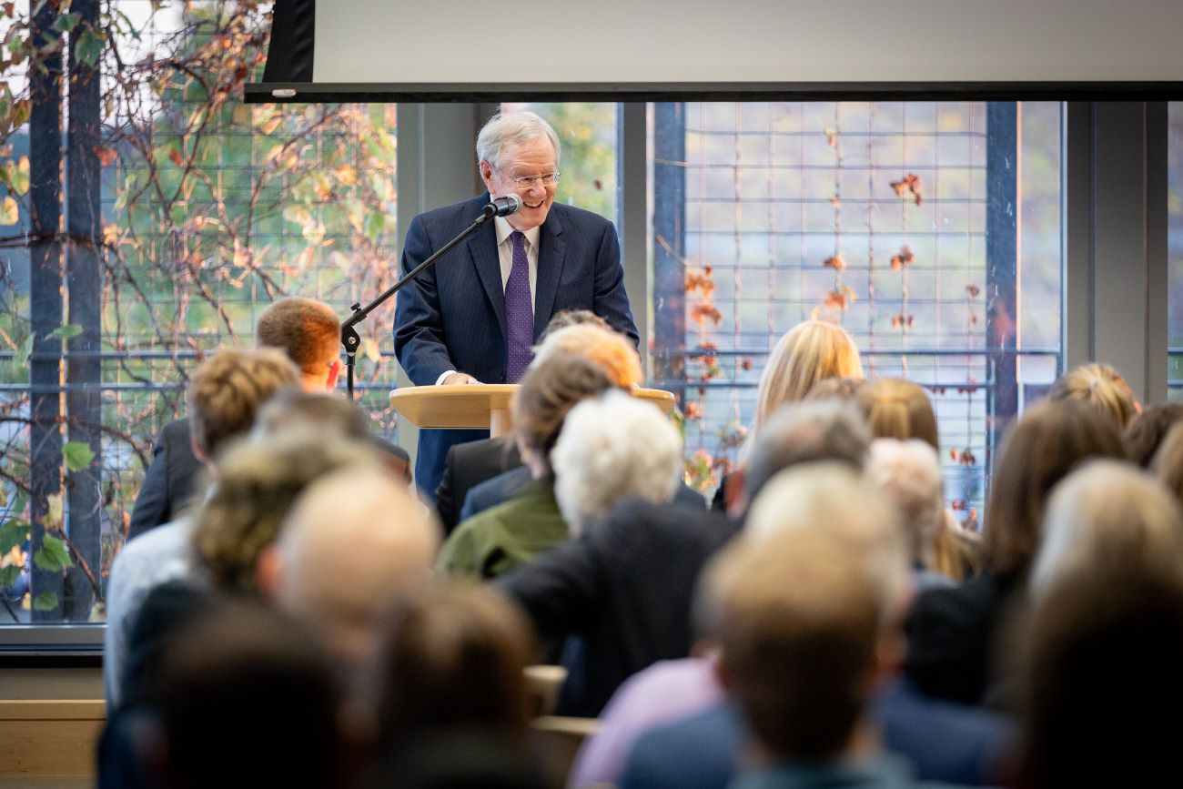 man at podium in front of crowd