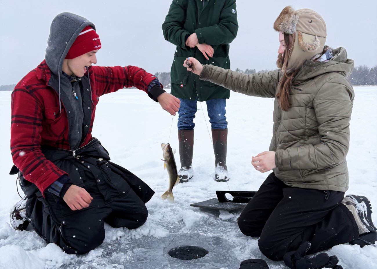 two students ice fishing