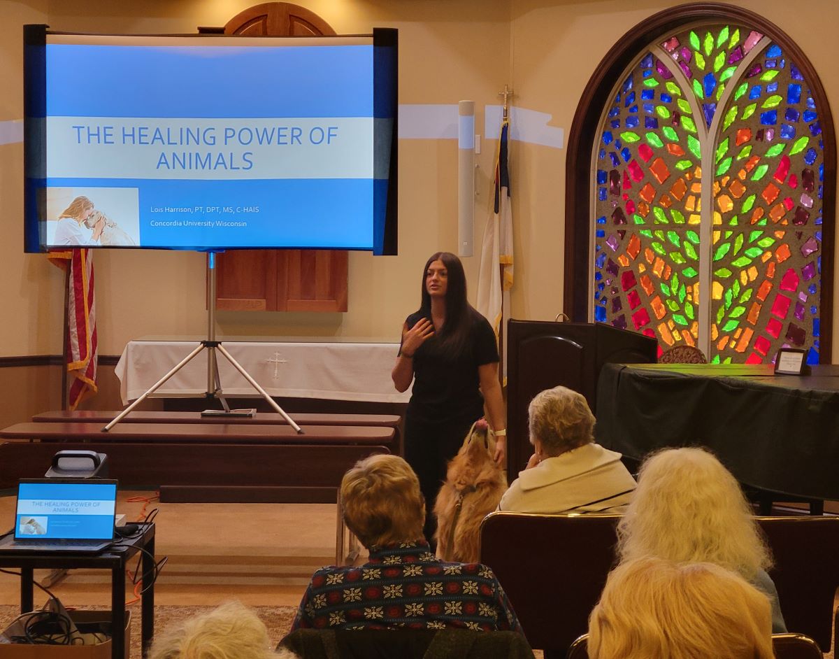 student with dark hair and dog