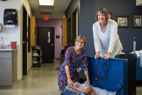 Assistant Professor of Nursing Cathy Cero-Jaeger and School of Nursing Dean Dr. Sharon Chappy pack supplies for a trip to Tanzania.