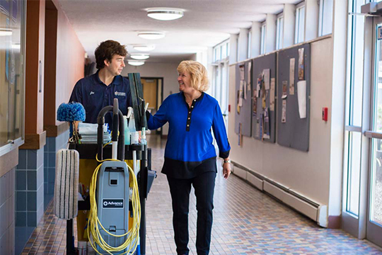 Concordia’s Dean of the School of Health Professions (right) walks Concordia's hallways with her son, Joe, who is a recent graduate of Bethesda College.