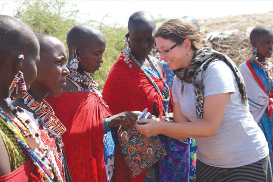Julie distributes reusable sanitary packs to Maasai mothers and daughters in rural Kenya.