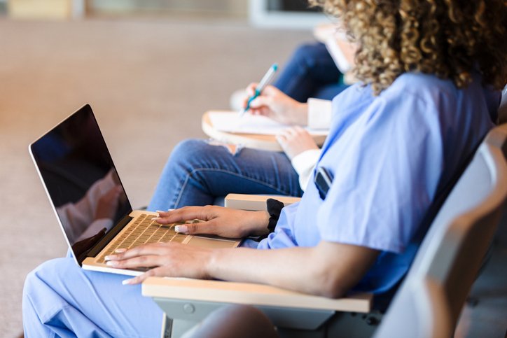 Nursing student typing on laptop