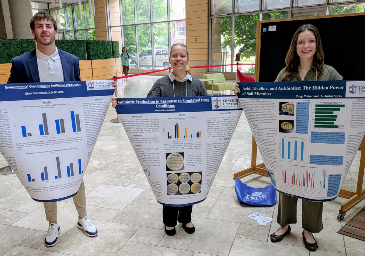 three people holding signs up