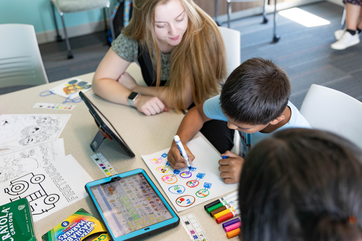 student teaching child at table