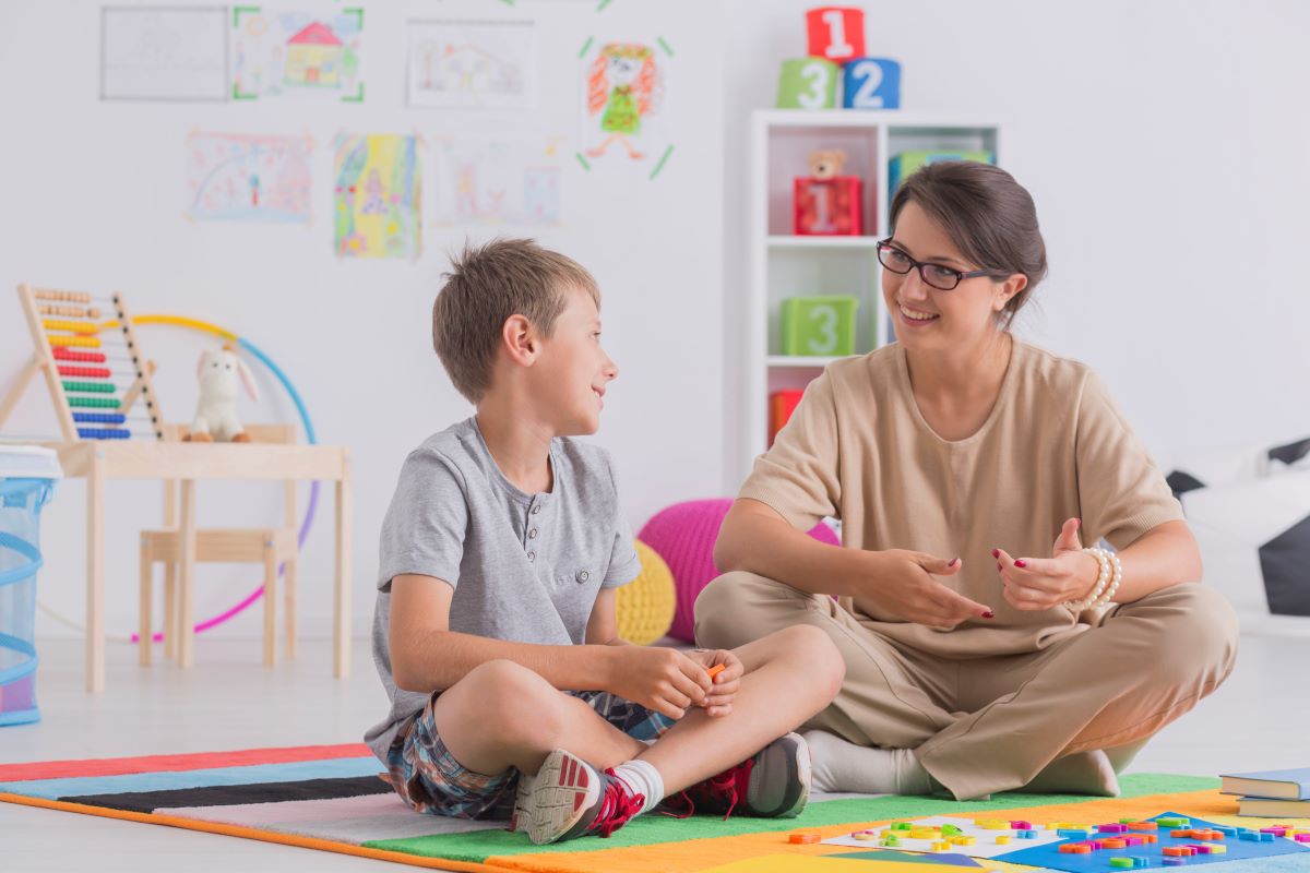 woman sitting with kid on floor